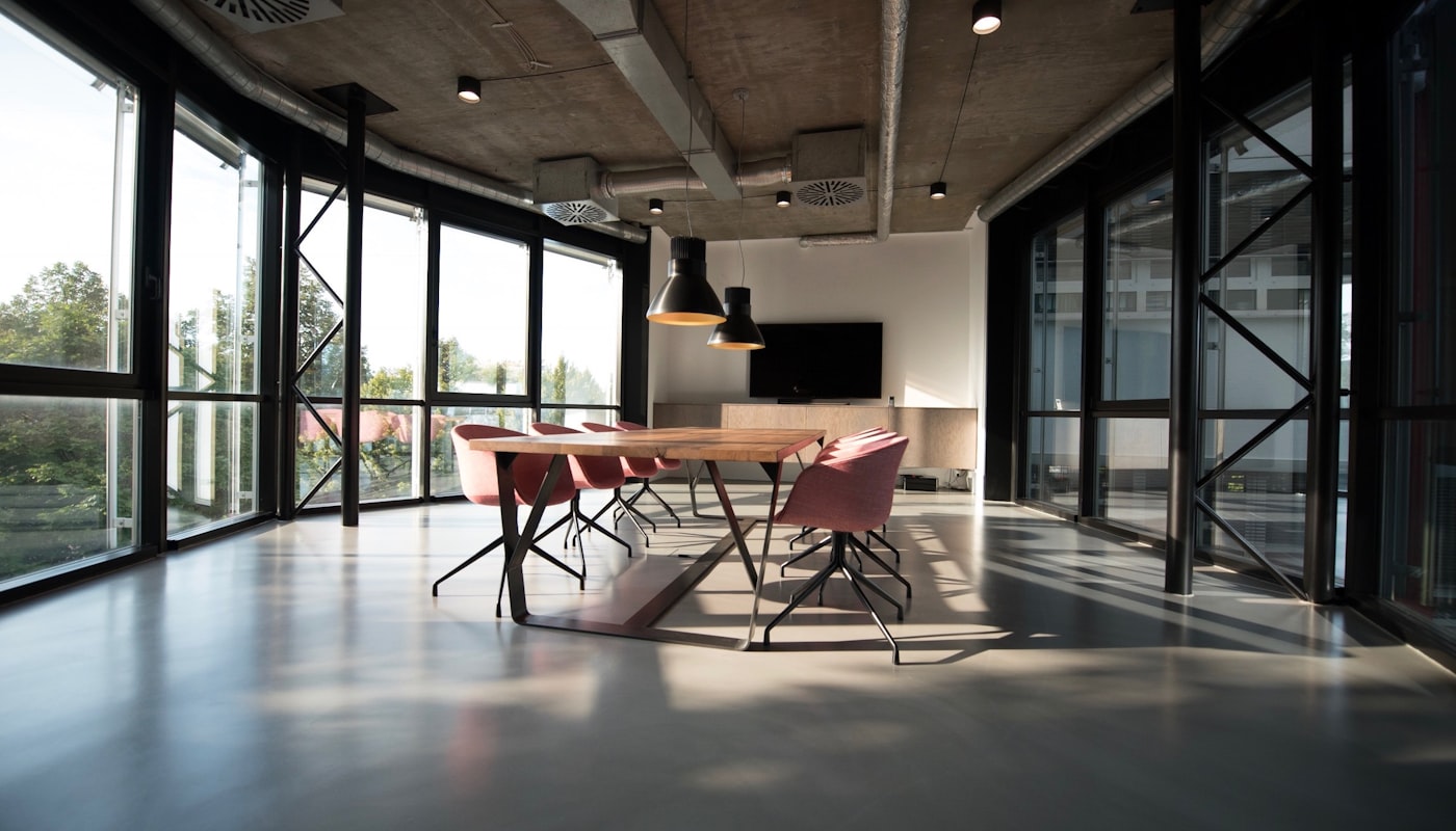 The modern Spotto Finance mortgage broking office interior in Dandenong, with a meeting table and warm natural light through floor-to-ceiling windows
