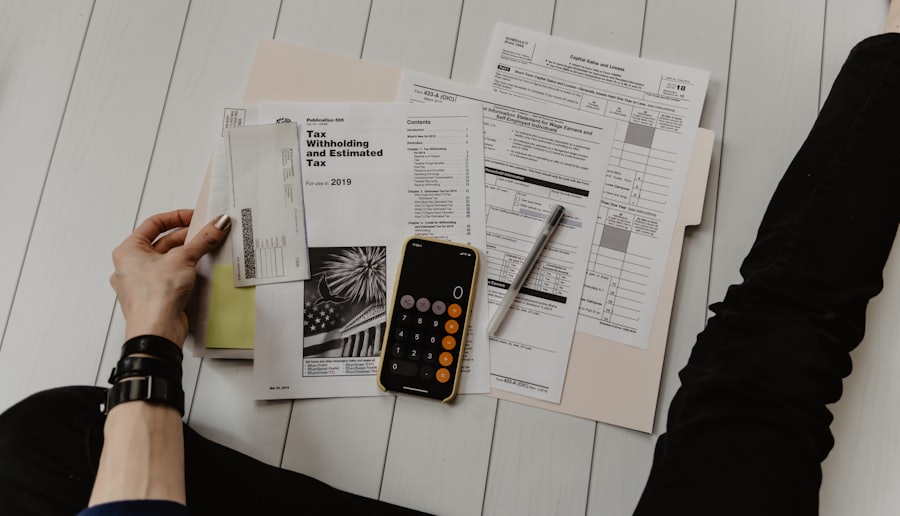 A person working through finances with a calculator and documents to assess borrowing power