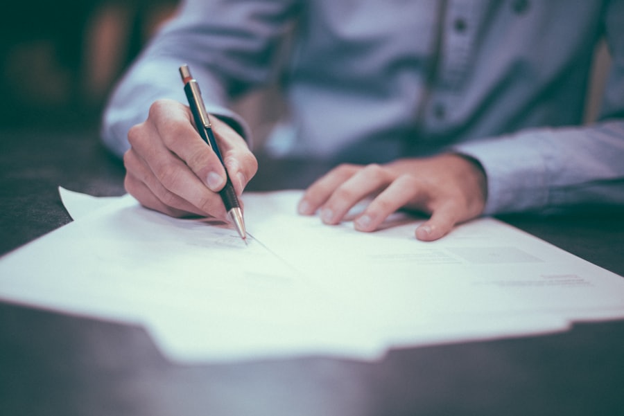 A person signing home loan paperwork with a pen