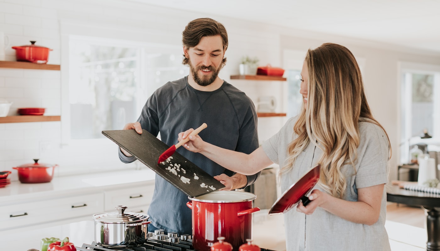 A happy couple enjoying their bright new-home kitchen after settling their home loan with Spotto Finance