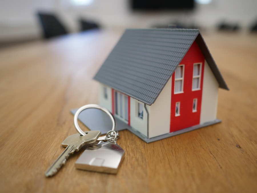 House keys beside a model home, representing settlement day